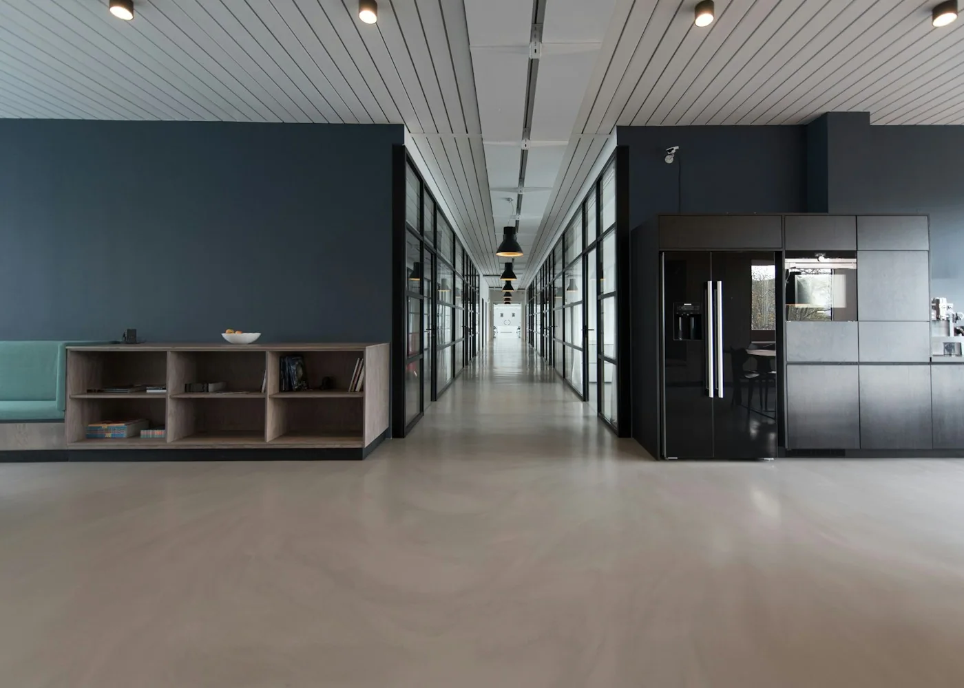 Light-filled commercial office lobby with seating and indoor planting