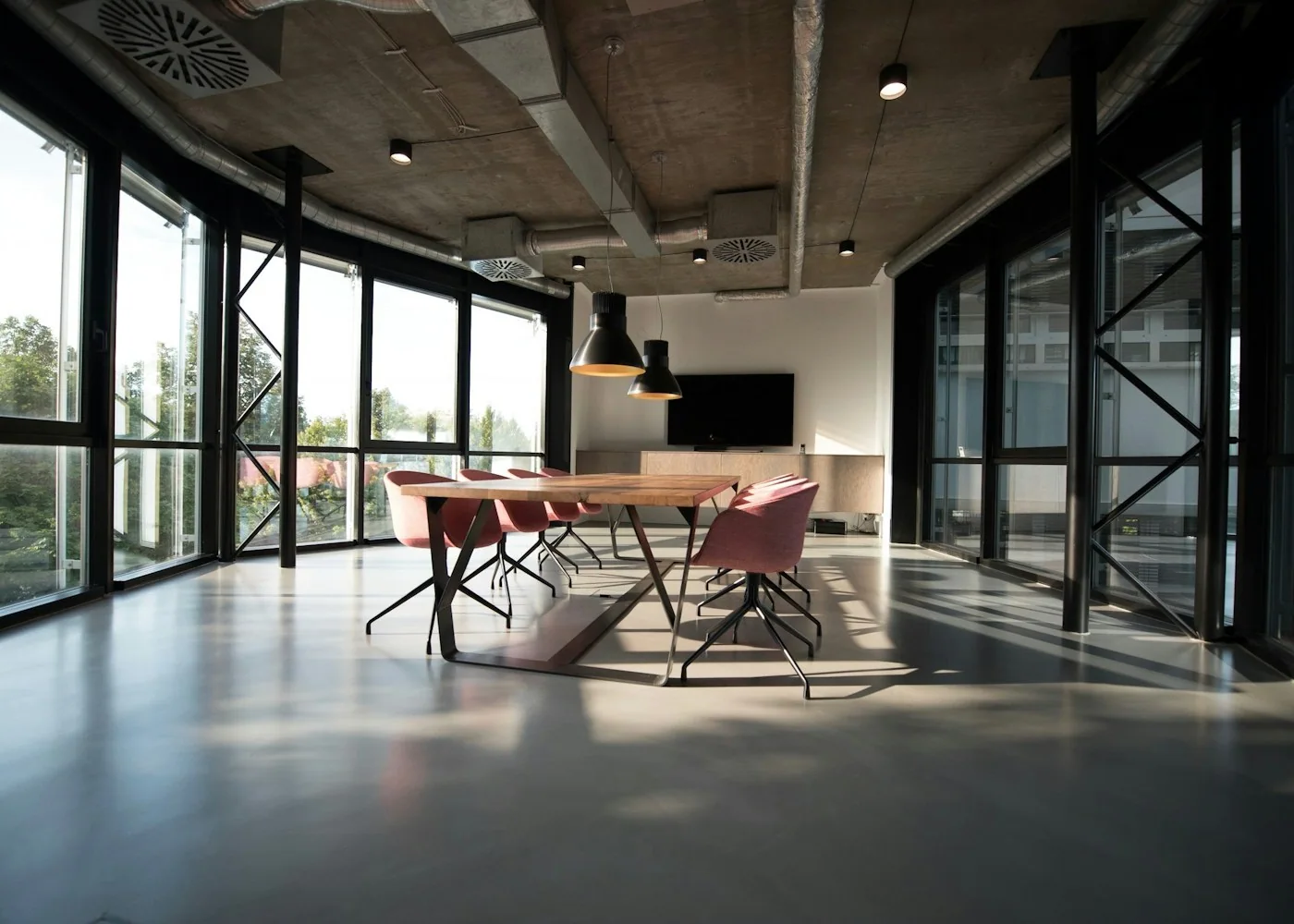 Glass-walled meeting room overlooking a commercial district